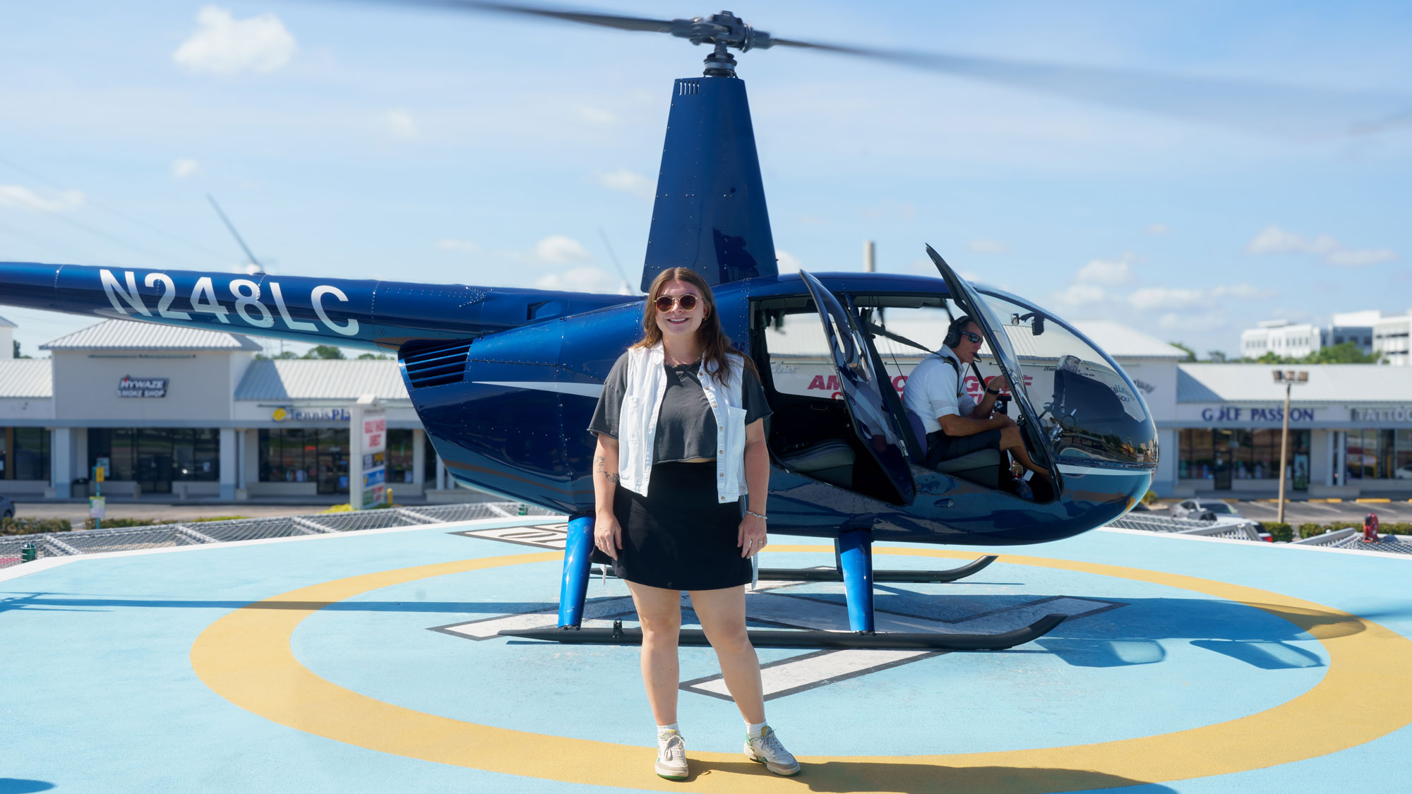 woman standing in front of an helicopter