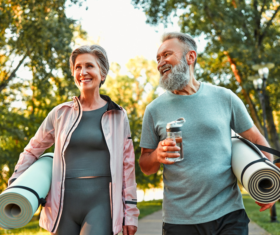 older couple with yoga mats
